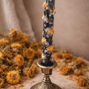 Black candle with calendula