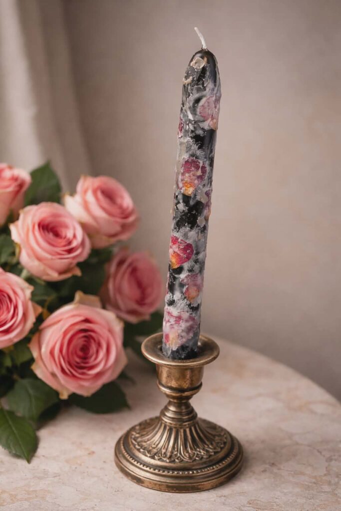 Black candle with roses